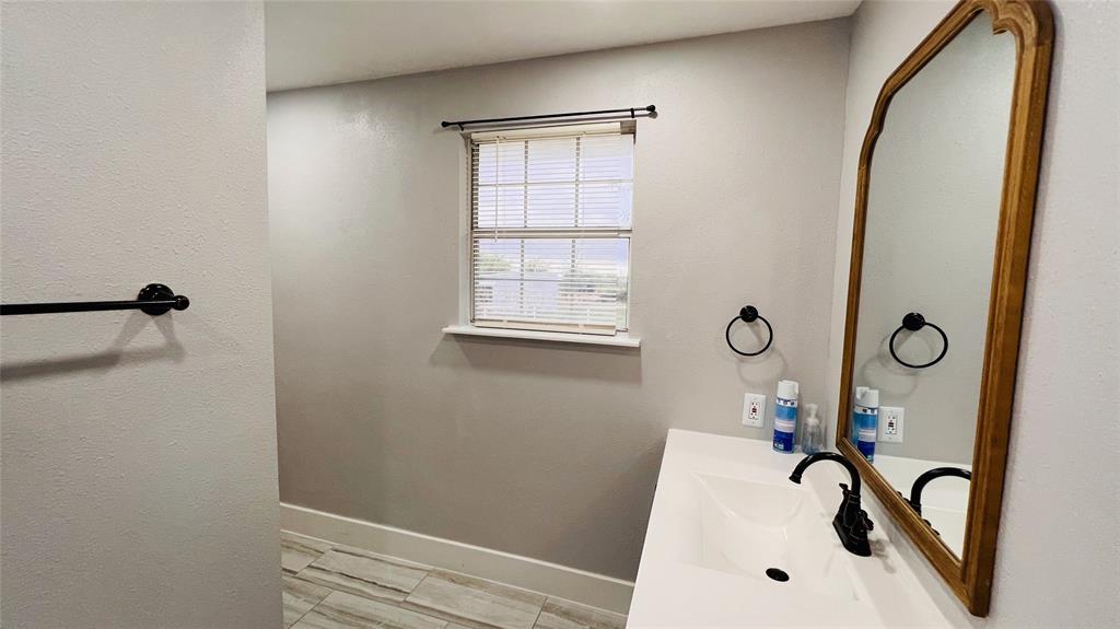 7301 Fishtrap Road Cross Roads, TX 76227 - Photo 22 of 40 a bathroom with a sink and a window