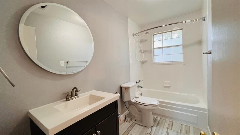 7301 Fishtrap Road Cross Roads, TX 76227 - Photo 26 of 40 a bathroom with a sink a toilet and a mirror