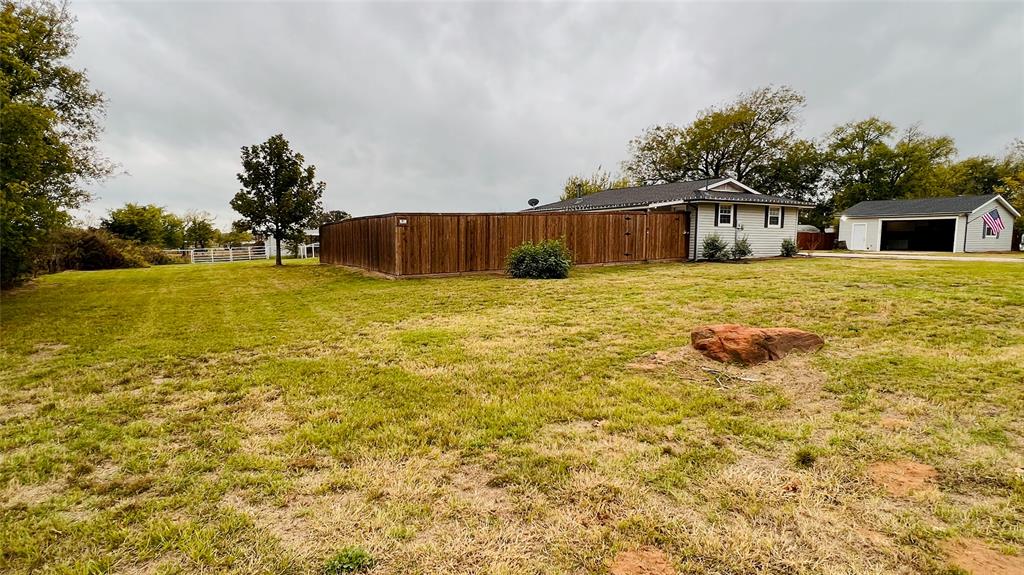 7301 Fishtrap Road Cross Roads, TX 76227 - Photo 7 of 40 a house with yard and trees in the background