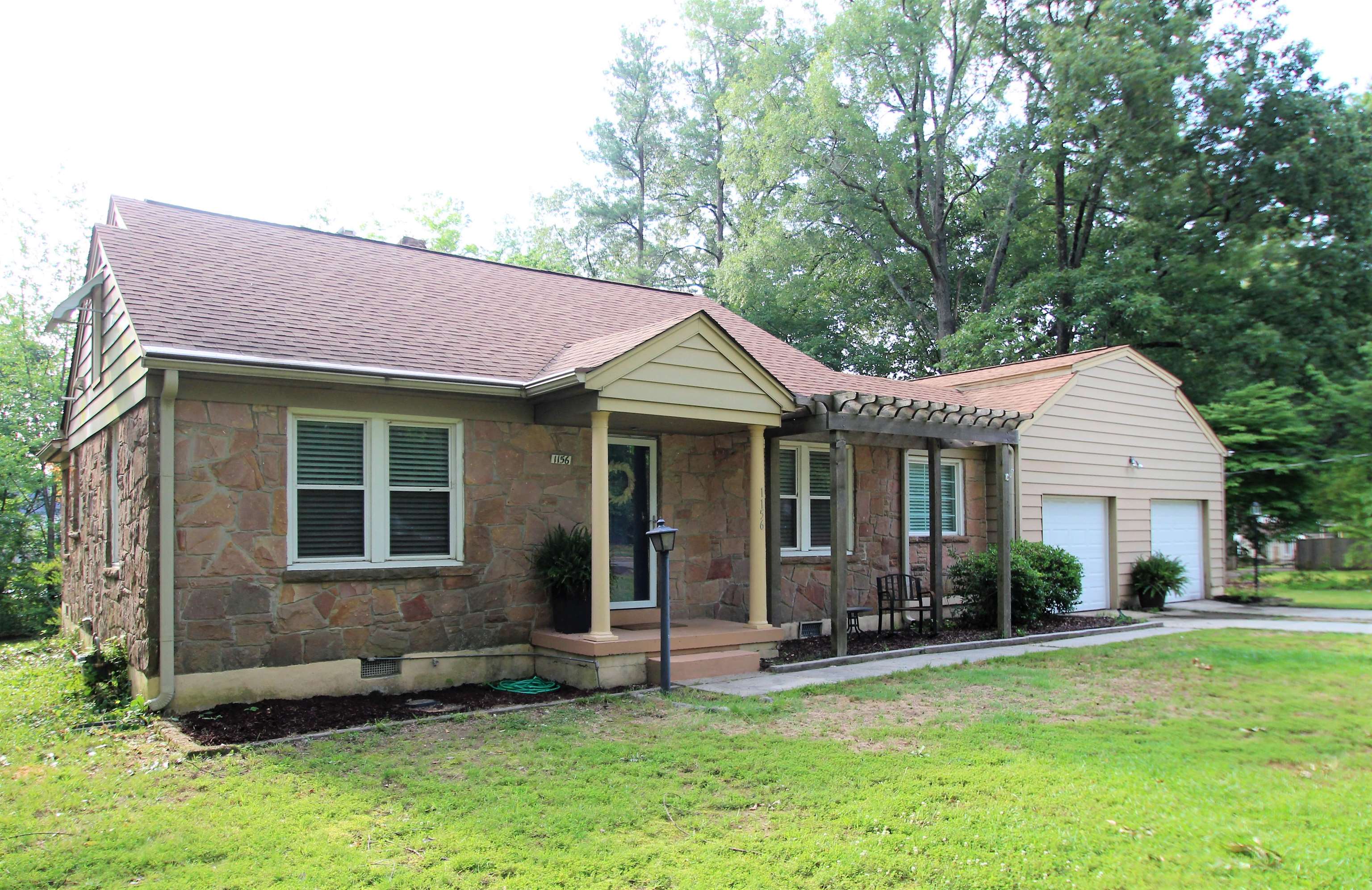 a front view of a house with a yard and porch