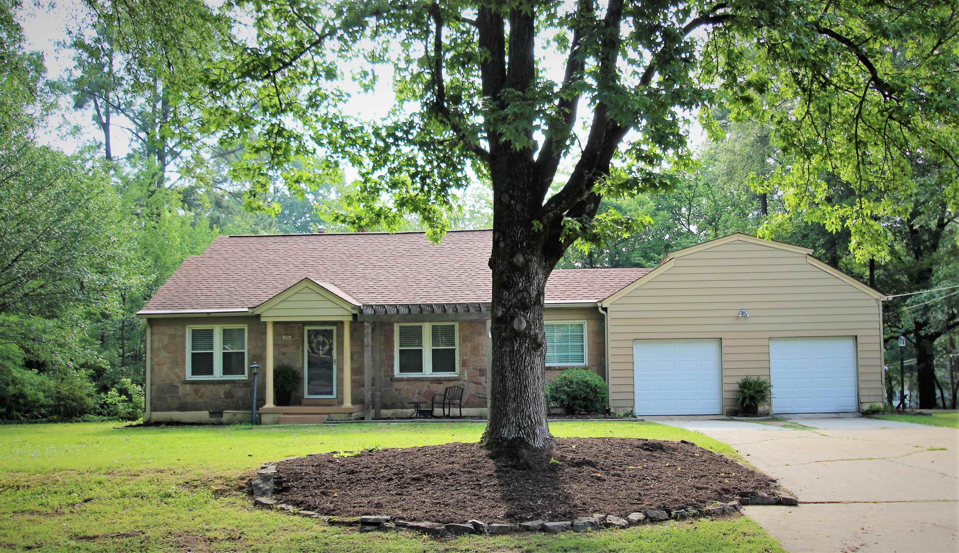 1156 Hayne Road Memphis, TN 38119 - Photo 20 of 25 a front view of a house with a yard and trees