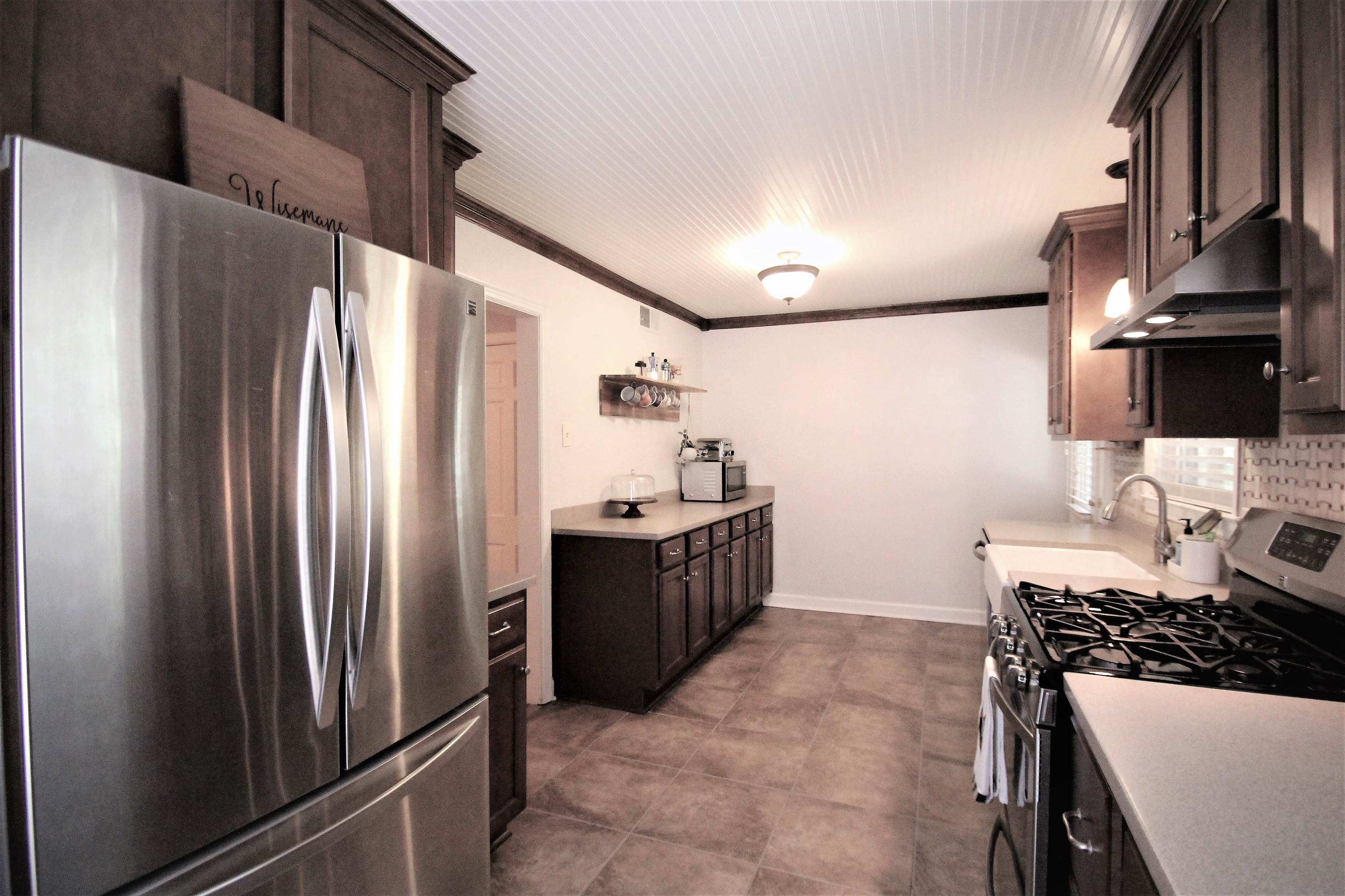1156 Hayne Road Memphis, TN 38119 - Photo 3 of 25 a kitchen with stainless steel appliances a refrigerator and a stove