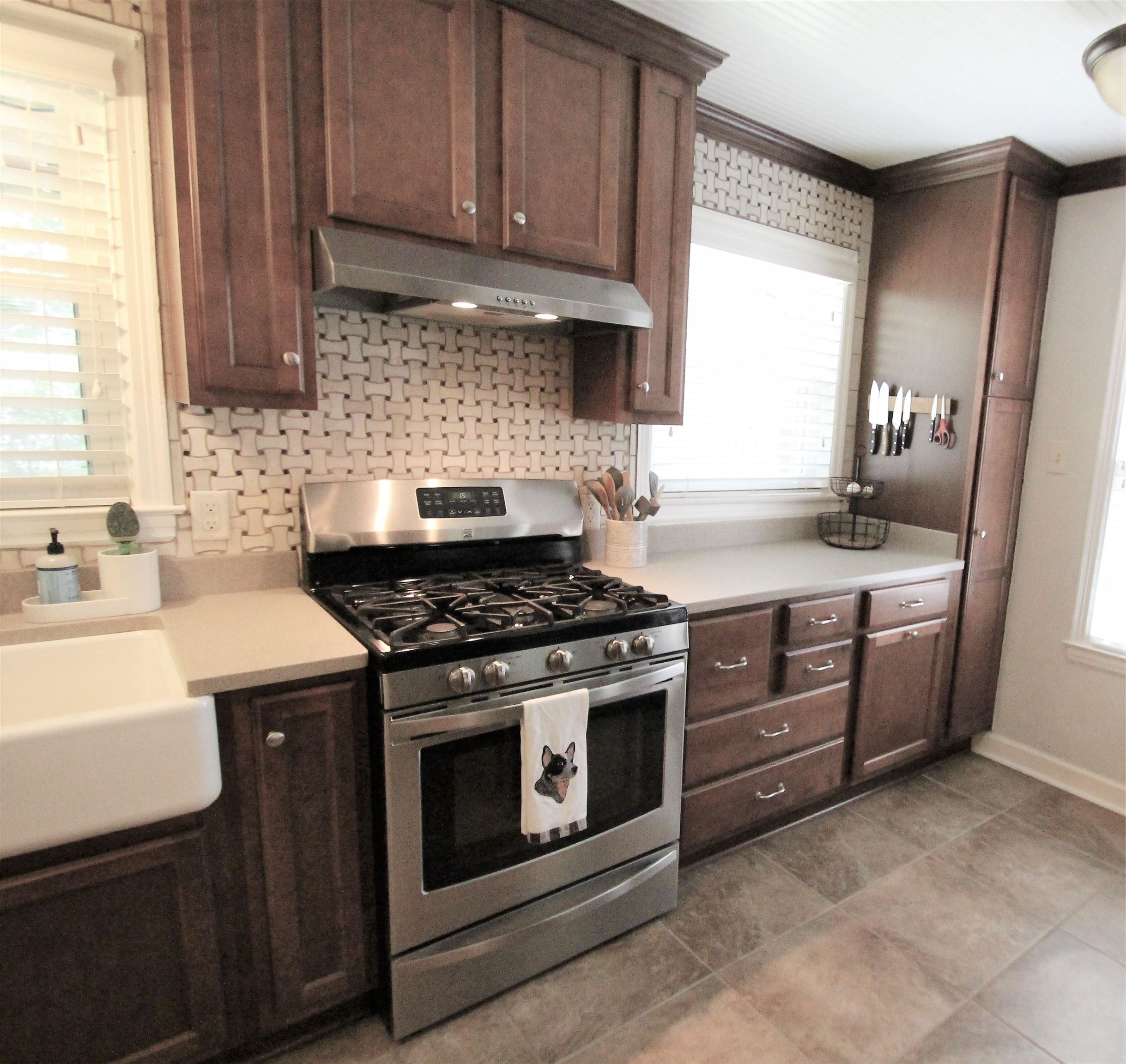 1156 Hayne Road Memphis, TN 38119 - Photo 4 of 25 a kitchen with stainless steel appliances granite countertop a sink stove and cabinets