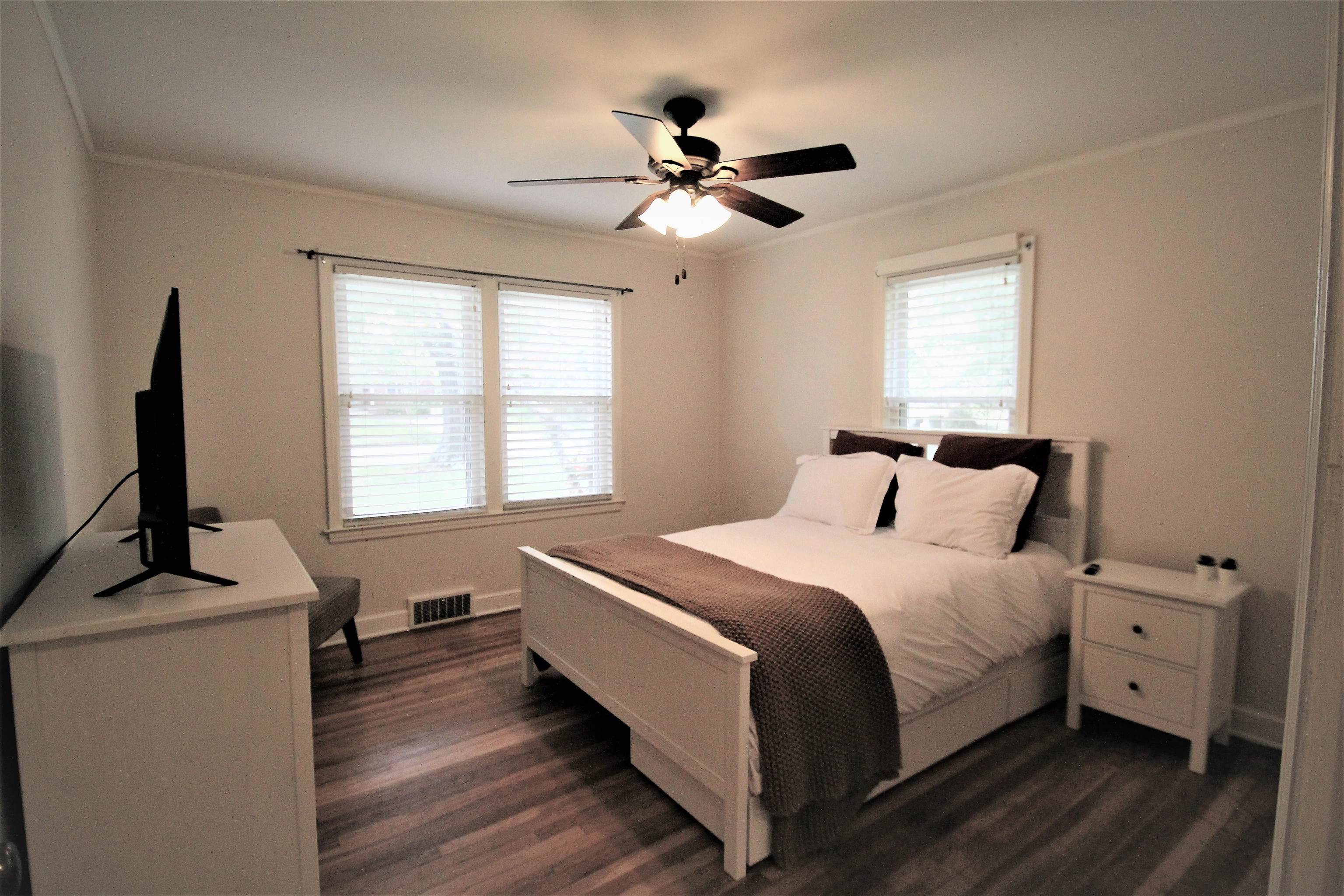 1156 Hayne Road Memphis, TN 38119 - Photo 7 of 25 a bedroom with a bed and a flat tv screen on a dresser