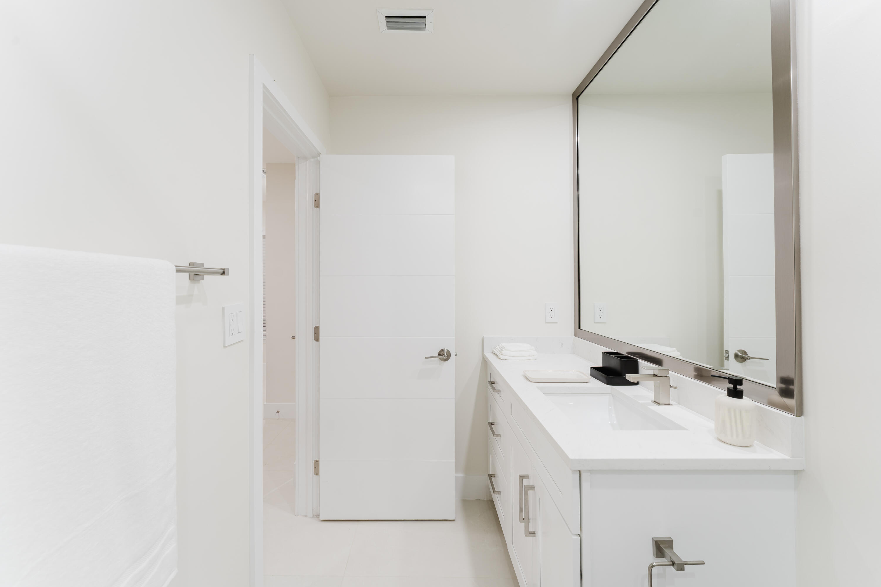 3199 Northeast 6th Drive Boca Raton, FL 33431 - Photo 30 of 49 a bathroom with a sink and a mirror