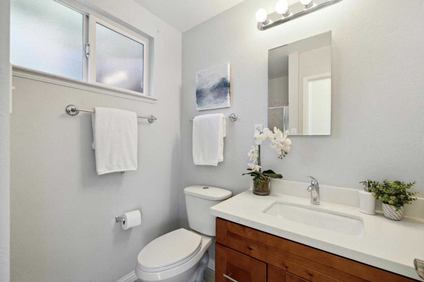 3230 Longview Drive San Bruno, CA 94066 - Photo 12 of 23 a bathroom with a sink vanity mirror and toilet
