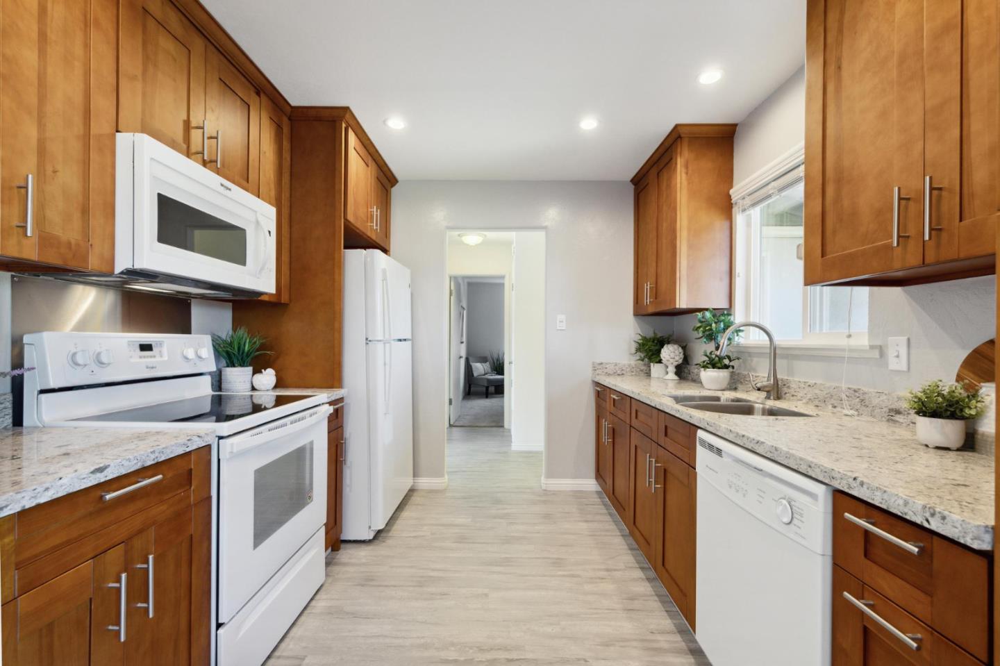3230 Longview Drive San Bruno, CA 94066 - Photo 8 of 23 a kitchen with stainless steel appliances granite countertop a stove a sink and a microwave