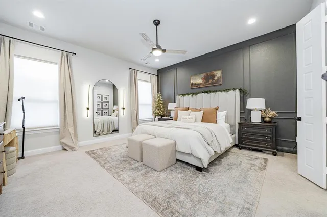 a spacious bedroom with a bed and a chandelier