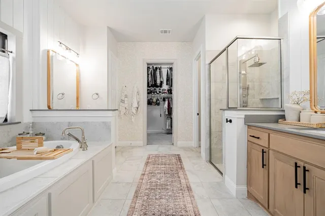 a bathroom with a sink a mirror and a shower