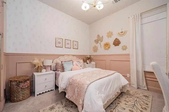 a bedroom with a bed and a potted plant