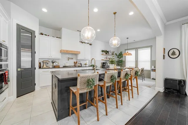 a large kitchen with a table and chairs
