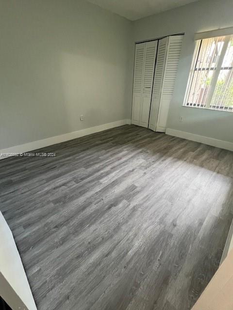2622 North Nob Hill Road, Unit 2622 Sunrise, FL 33322 - Photo 12 of 16 an empty room with wooden floor and windows