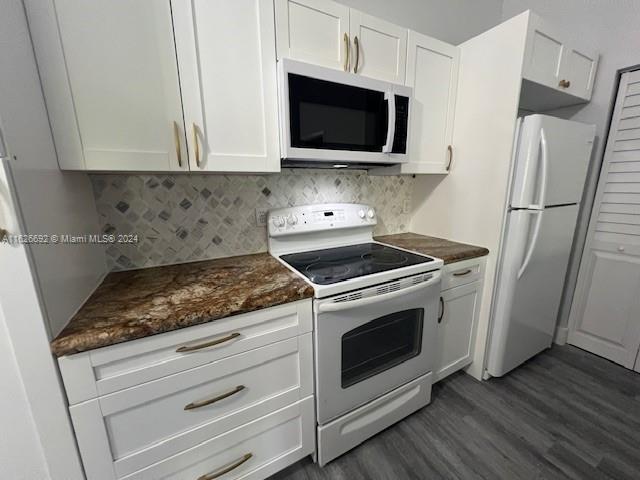 2622 North Nob Hill Road, Unit 2622 Sunrise, FL 33322 - Photo 3 of 16 a kitchen with stainless steel appliances white cabinets and a stove top oven