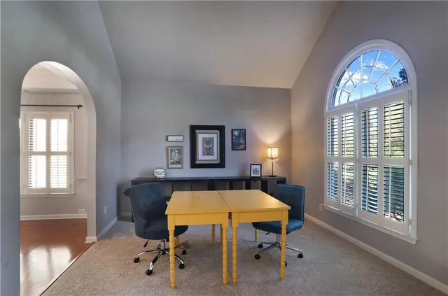 a view of a livingroom with furniture and a window