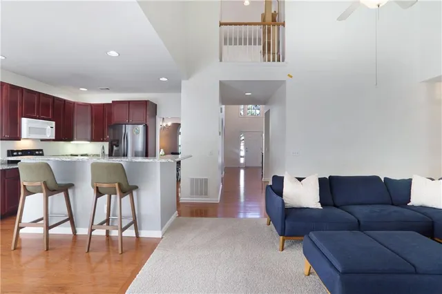 a living room with furniture and a dining table with kitchen view