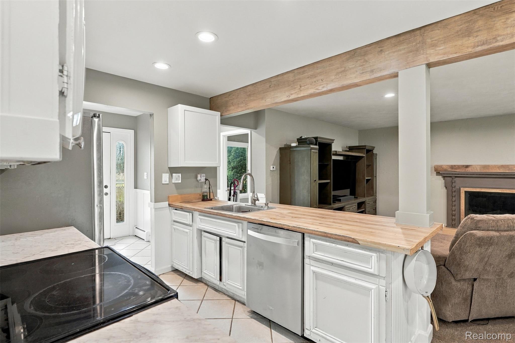 26516 Romine Road New Boston, MI 48164 - Photo 12 of 62 Kitchen with white cabinetry, wood-finish countertops, tile flooring, and recessed lighting