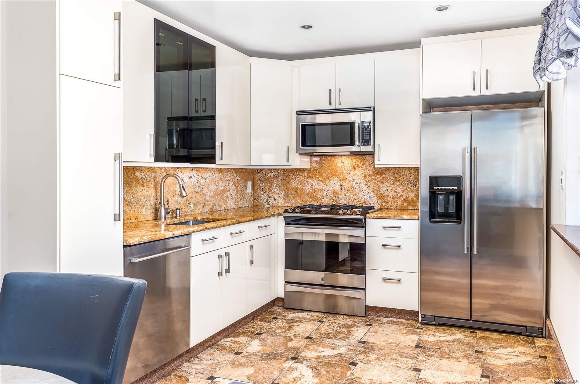 72-52 Metropolitan Avenue, Unit 2A Queens, NY 11379 - Photo 1 of 1 a kitchen with stainless steel appliances kitchen island granite countertop a refrigerator stove and sink