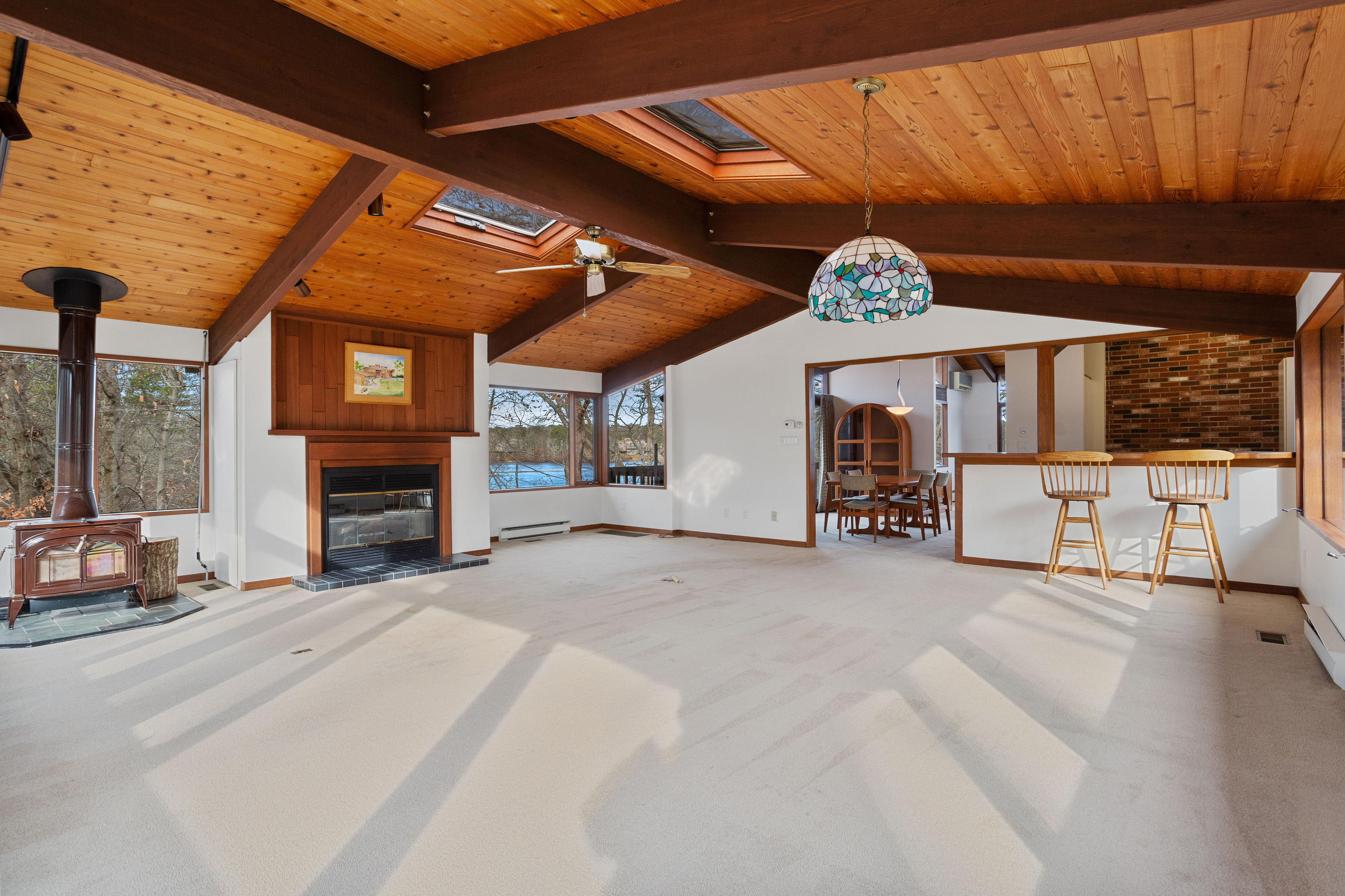 278 Huckins Neck Road Centerville, MA 02601 - Photo 25 of 52 a view of a hall with windows and a fireplace