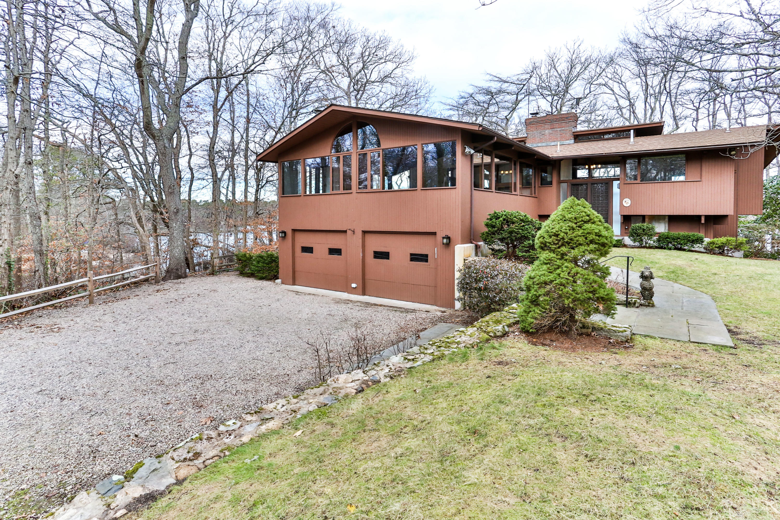 278 Huckins Neck Road Centerville, MA 02601 - Photo 4 of 52 a front view of a house with a yard and garage