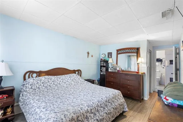 a bedroom with a bed and dresser