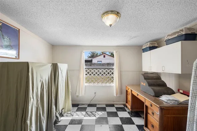 a living room with furniture a air conditioner and a window