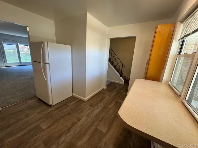 a view of a room with wooden floor and staircase