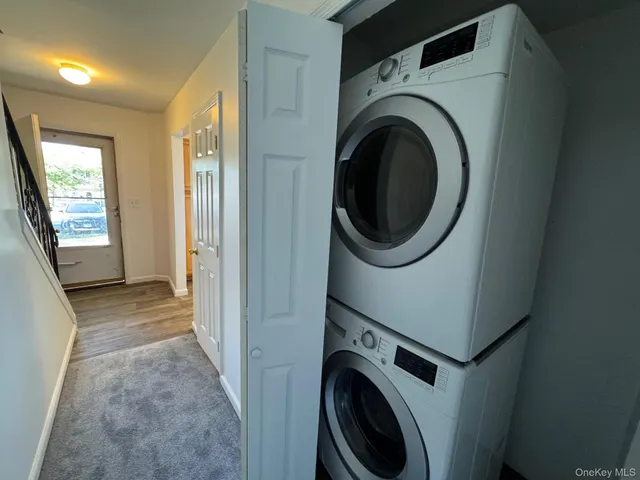 a view of a hallway with washer and dryer
