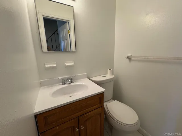 a bathroom with a sink toilet and mirror