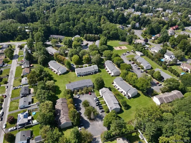 an aerial view of a residential houses with outdoor space
