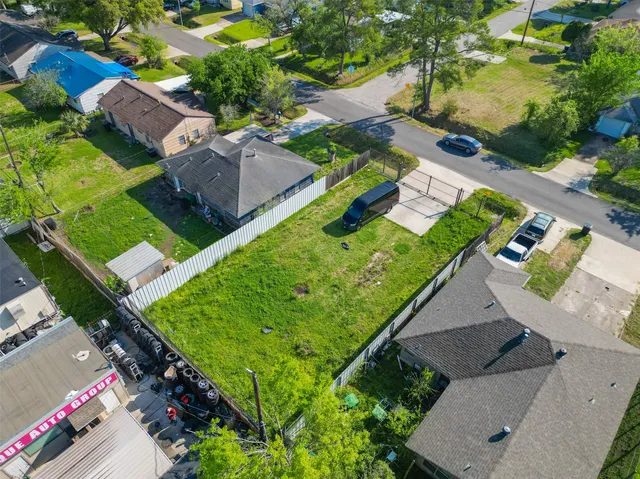 an aerial view of a house with a garden and swimming pool