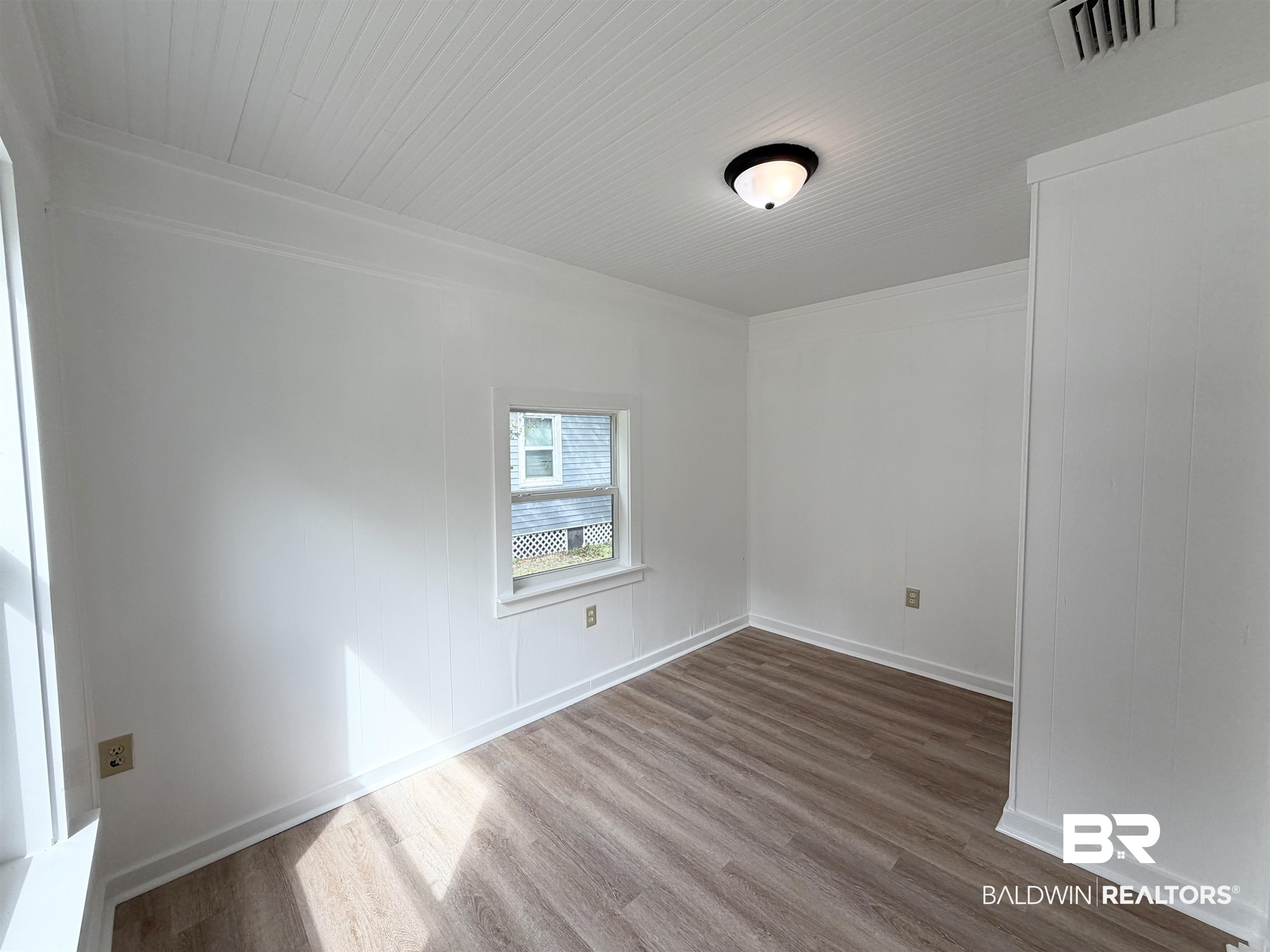 606 Shady Oak Drive Mobile, AL 36608 - Photo 11 of 14 Spare room featuring dark wood finished floors and baseboards