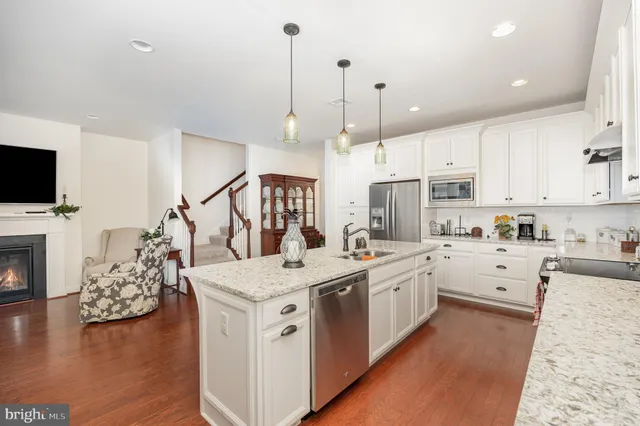 a kitchen with a stove a sink and a refrigerator
