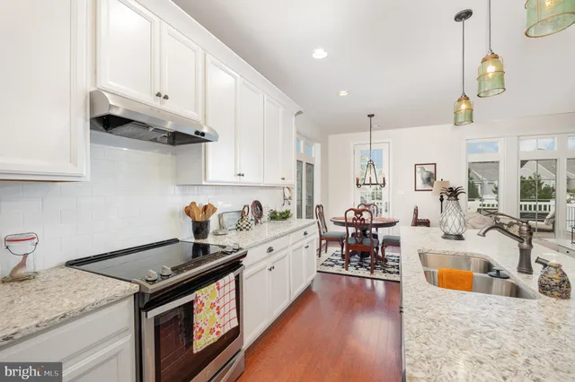 a kitchen with stainless steel appliances granite countertop a stove and a sink