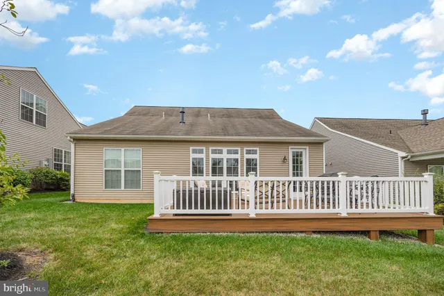 a view of a house with a yard and deck