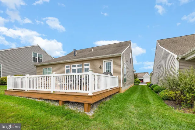 a view of backyard with deck and garden