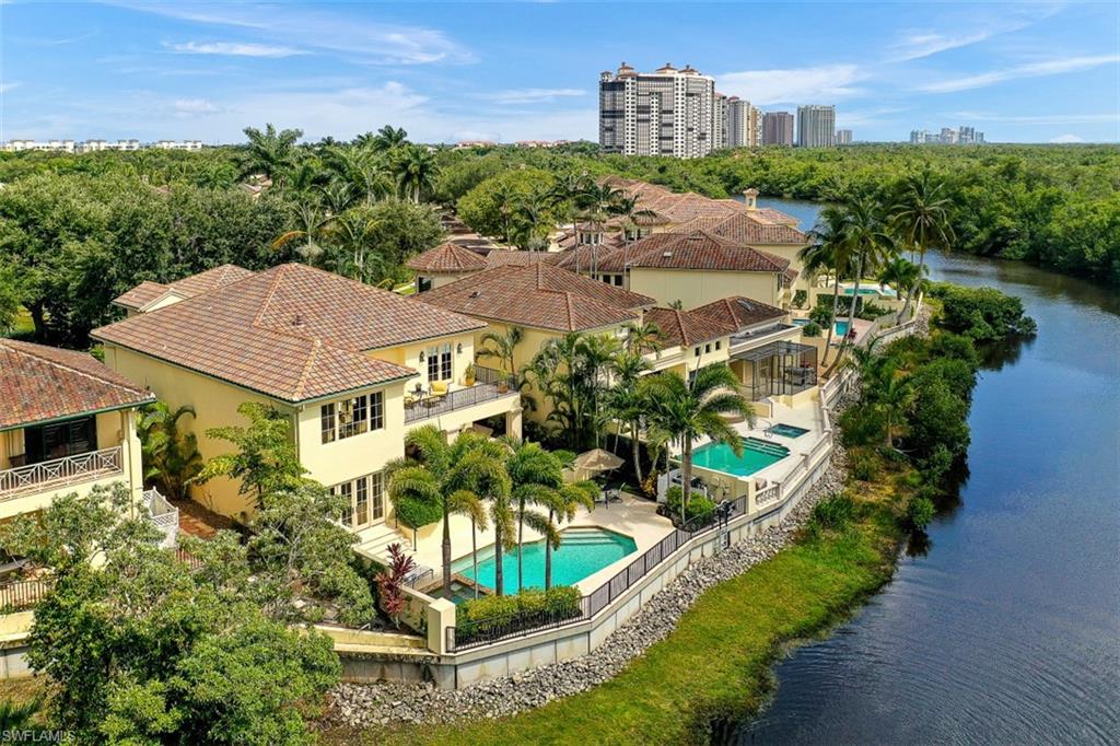 a view of a house with a yard and potted plants