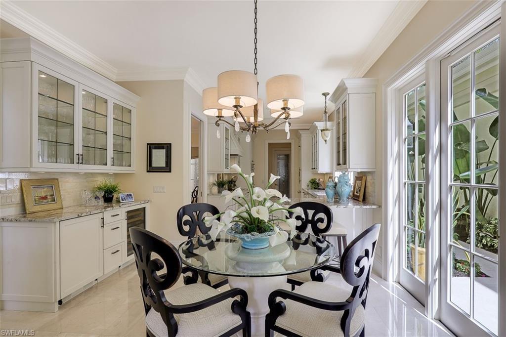 8121 Via Vecchia Naples, FL 34108 - Photo 13 of 35 a view of a dining room with furniture and a chandelier