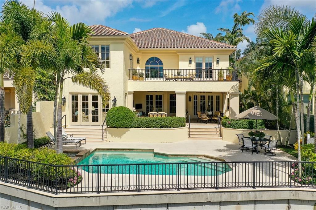 8121 Via Vecchia Naples, FL 34108 - Photo 2 of 35 a view of a white house with a small yard and plants