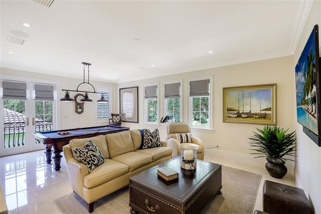 8121 Via Vecchia Naples, FL 34108 - Photo 22 of 35 a living room with furniture and a large window