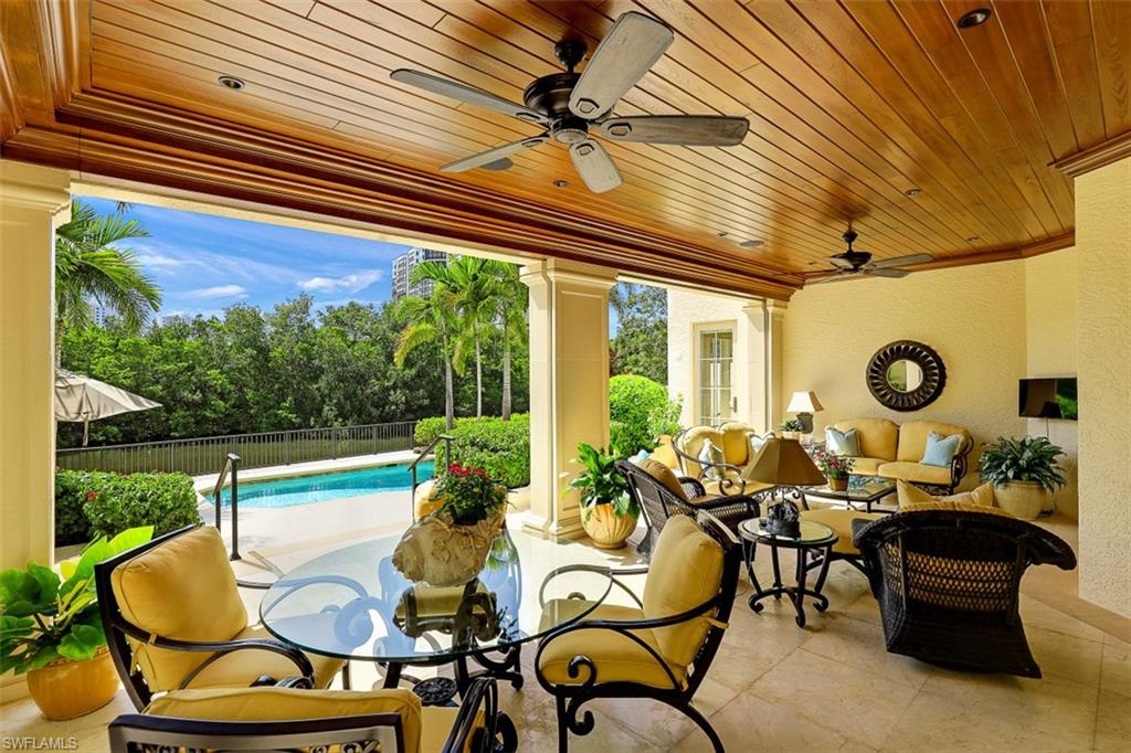 8121 Via Vecchia Naples, FL 34108 - Photo 29 of 35 a living room with patio furniture and a floor to ceiling window