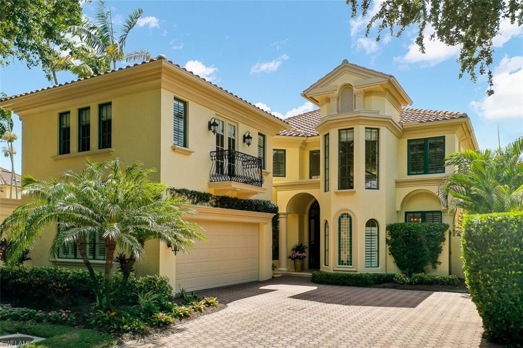 8121 Via Vecchia Naples, FL 34108 - Photo 3 of 35 a front view of a house with a yard