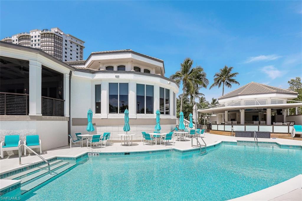 8121 Via Vecchia Naples, FL 34108 - Photo 32 of 35 a front view of a building with a garden and sitting area