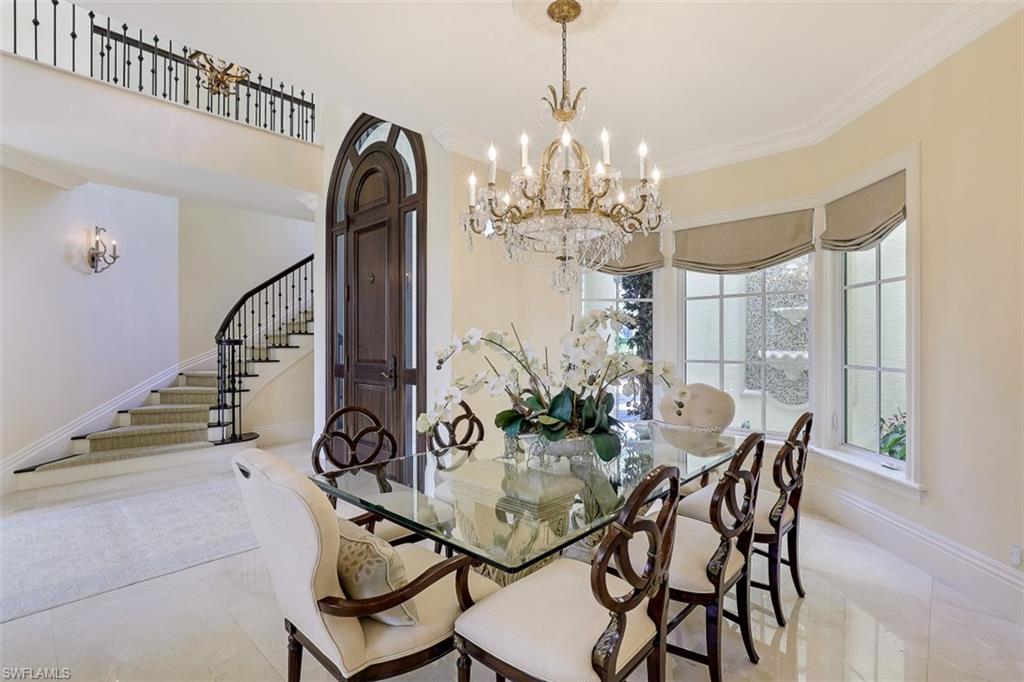 8121 Via Vecchia Naples, FL 34108 - Photo 5 of 35 a view of a dining room with furniture and chandelier