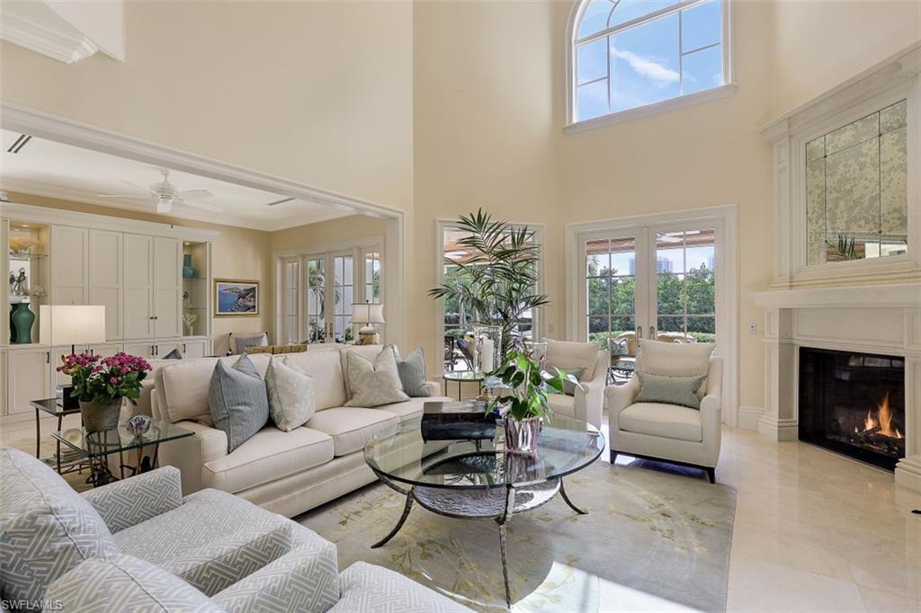 8121 Via Vecchia Naples, FL 34108 - Photo 6 of 35 a living room with furniture potted plant and a fireplace