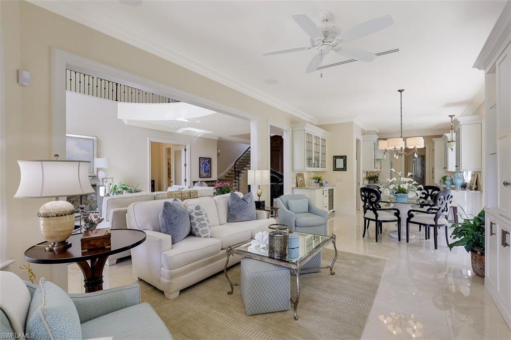 8121 Via Vecchia Naples, FL 34108 - Photo 8 of 35 a living room with furniture potted plant and a ceiling fan