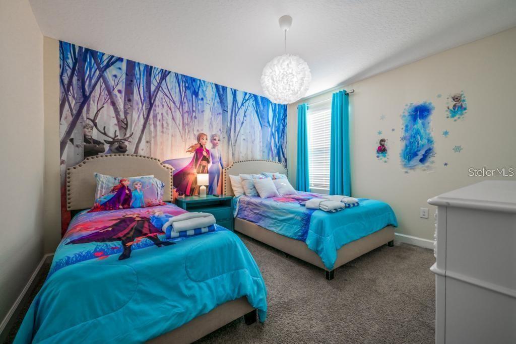 4532 Target Boulevard Kissimmee, FL 34746 - Photo 14 of 52 a bedroom with two beds and a chandelier