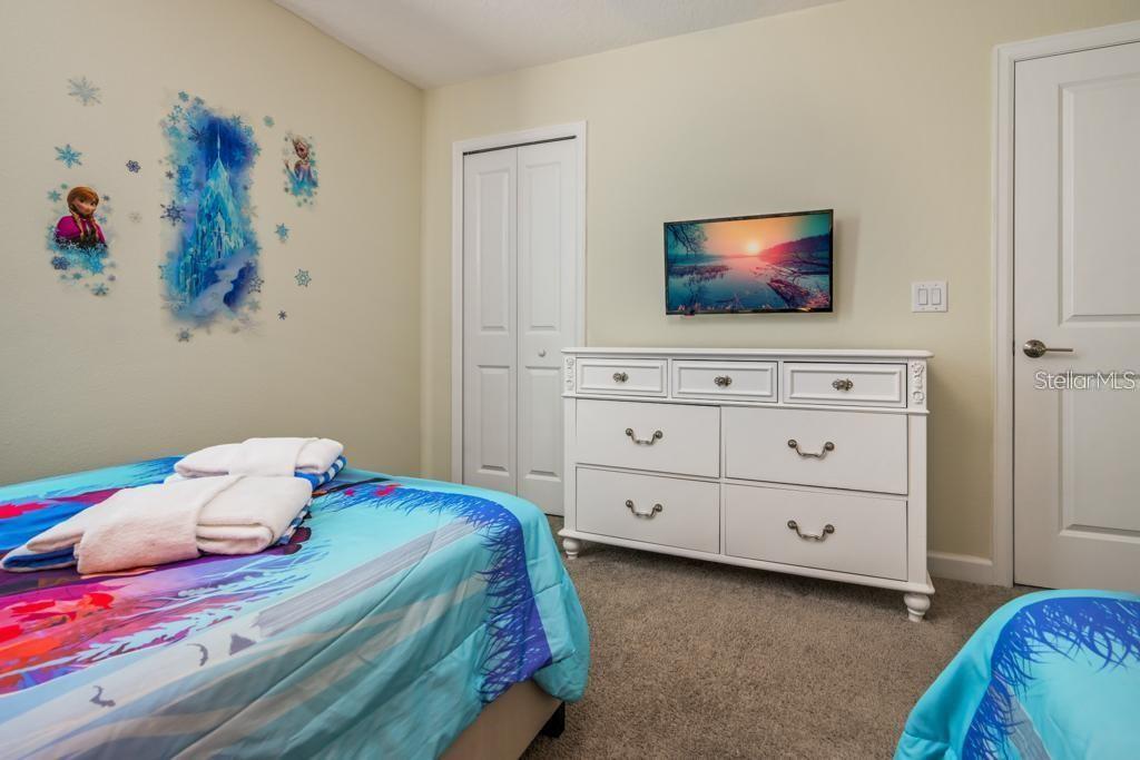 4532 Target Boulevard Kissimmee, FL 34746 - Photo 15 of 52 a bedroom with a bed and a flat screen tv