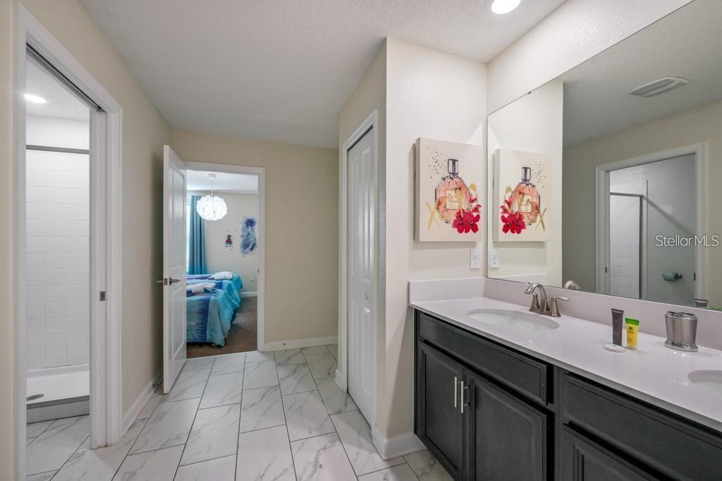 4532 Target Boulevard Kissimmee, FL 34746 - Photo 16 of 52 a bathroom with a sink vanity and mirror