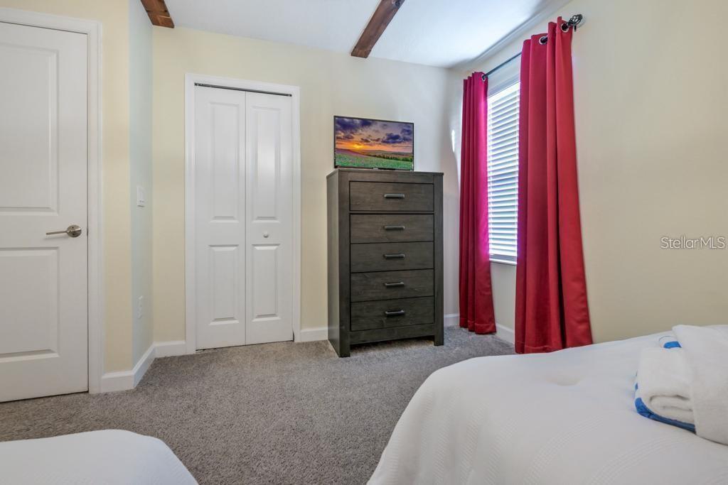 4532 Target Boulevard Kissimmee, FL 34746 - Photo 20 of 52 a bedroom with a bed and a mirror