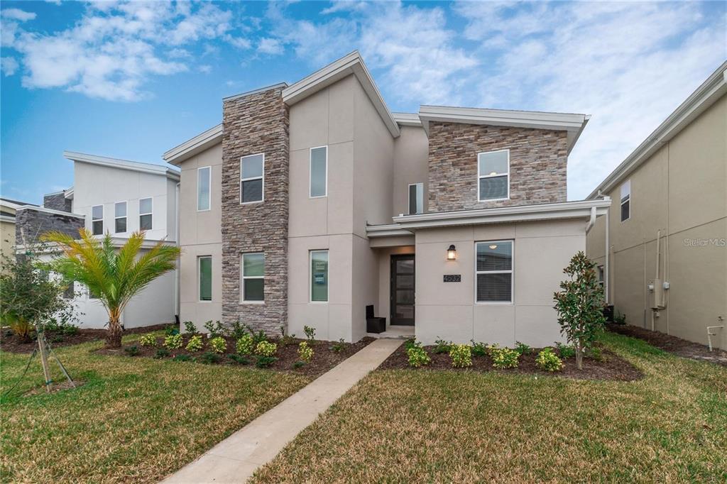 4532 Target Boulevard Kissimmee, FL 34746 - Photo 2 of 52 a front view of a house with garden